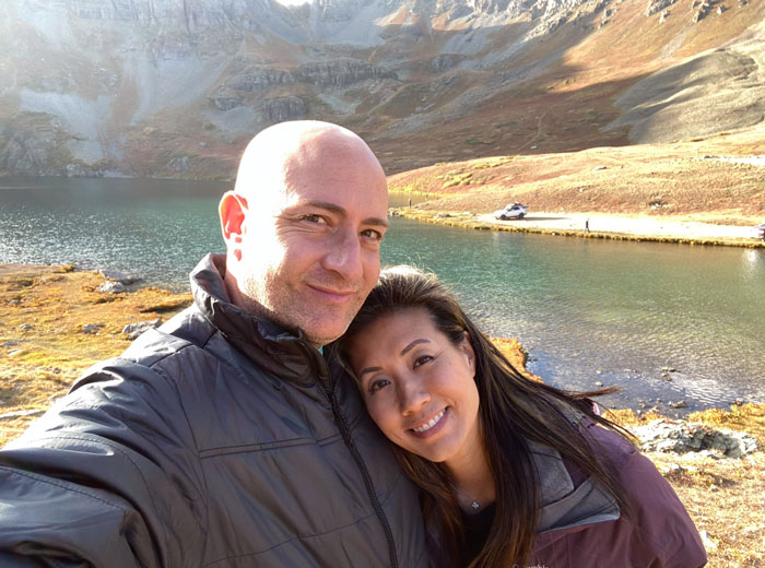 Couple and their Land Rover at a lake in Ouray Colorado